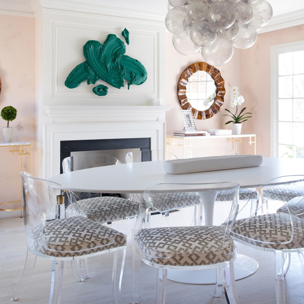 a room filled with furniture and vase of flowers on a table