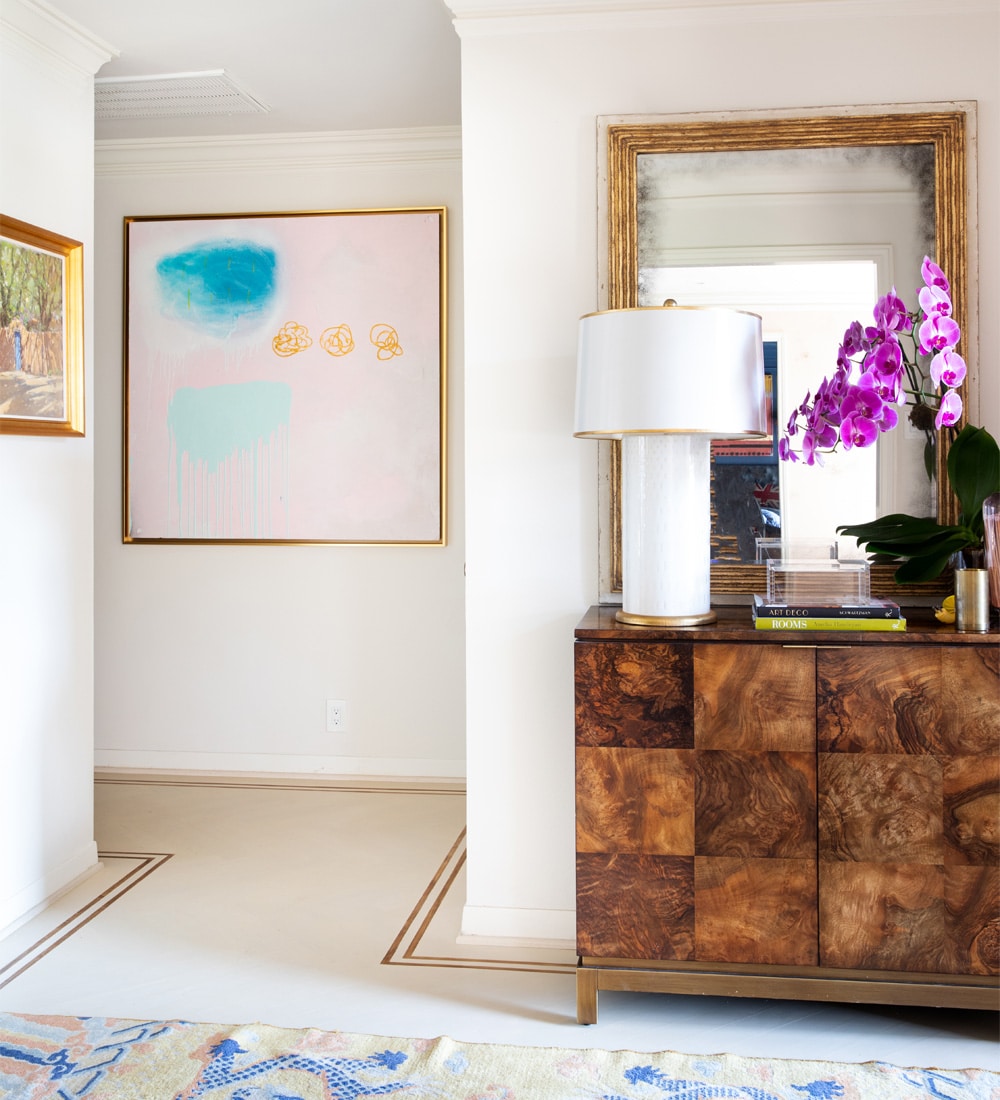 a living room filled with furniture and vase of flowers on a table