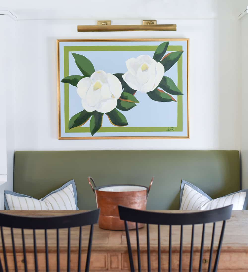 a room filled with furniture and vase of flowers on a table