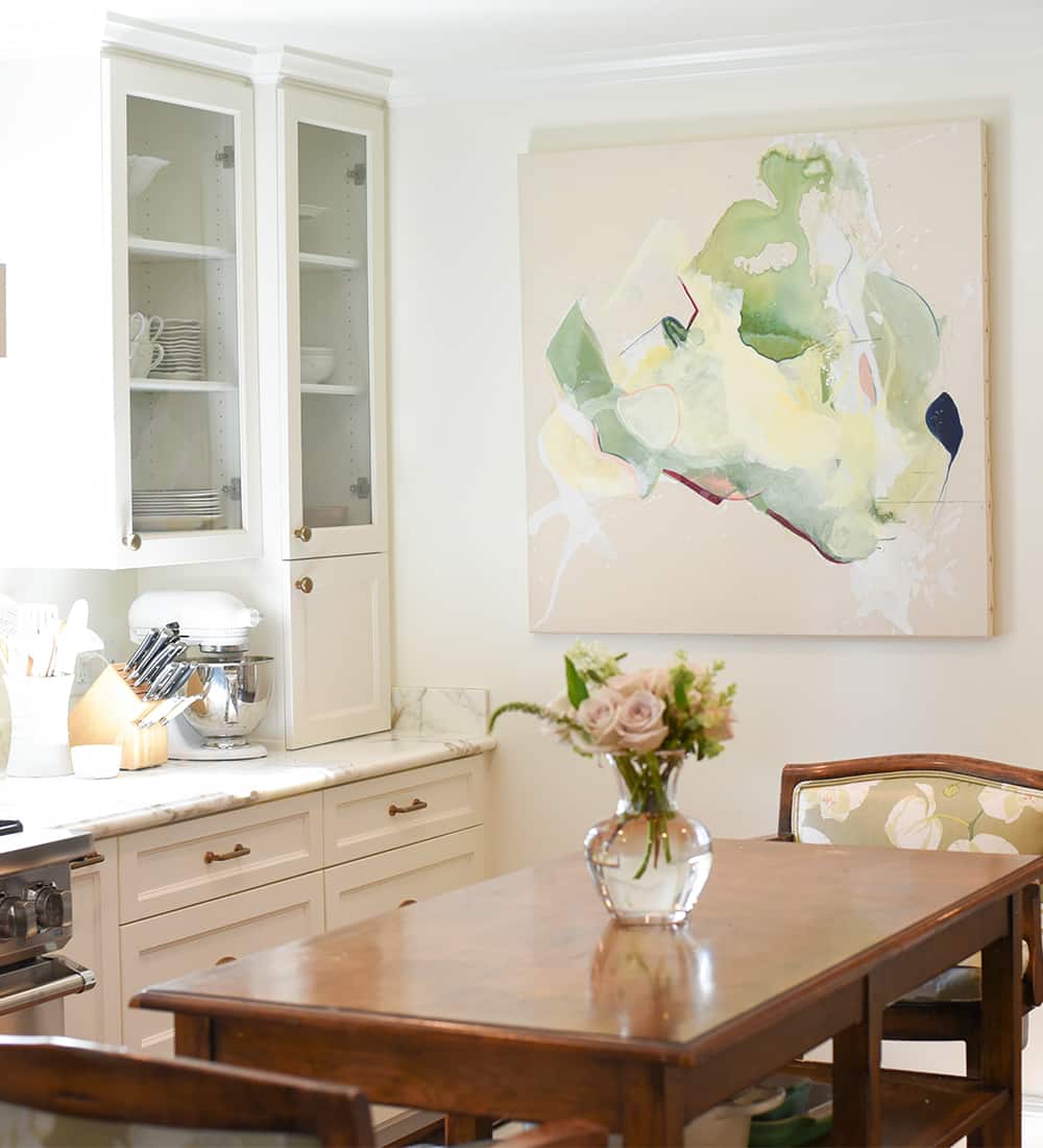 a room filled with furniture and vase of flowers on a table