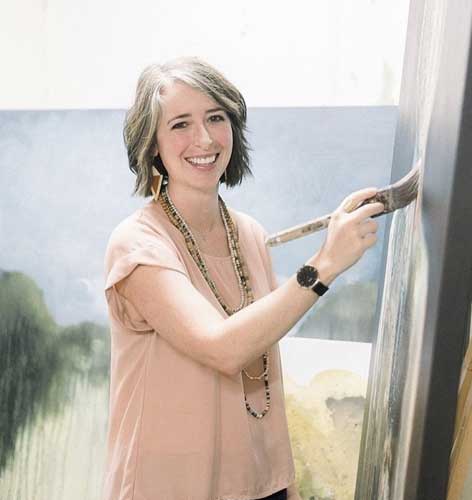 a woman standing in front of a window