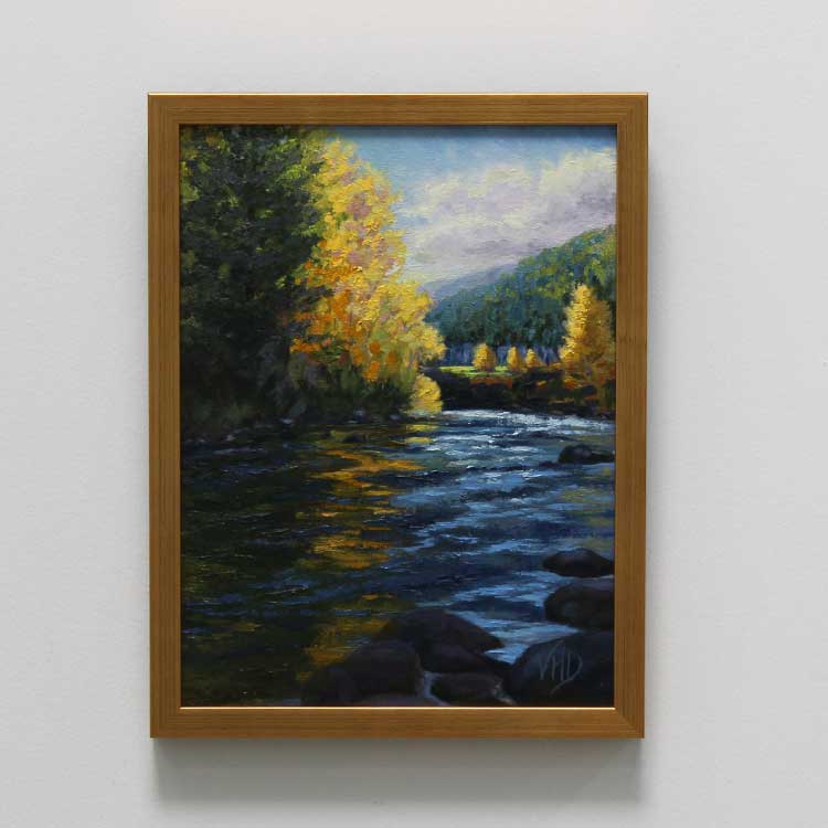 a painting in a frame hanging on a wall