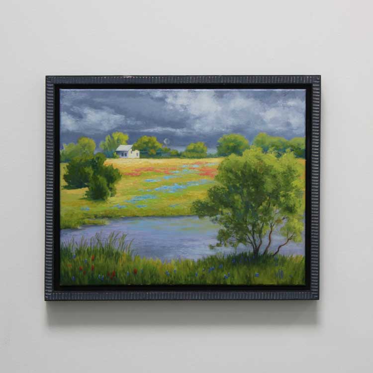 a painting in a frame hanging on a wall