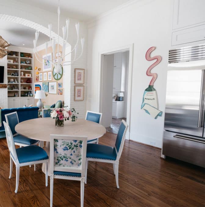 a kitchen with a table and chairs in a room