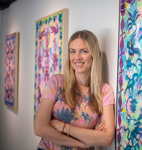 a person standing in front of a colorful wall